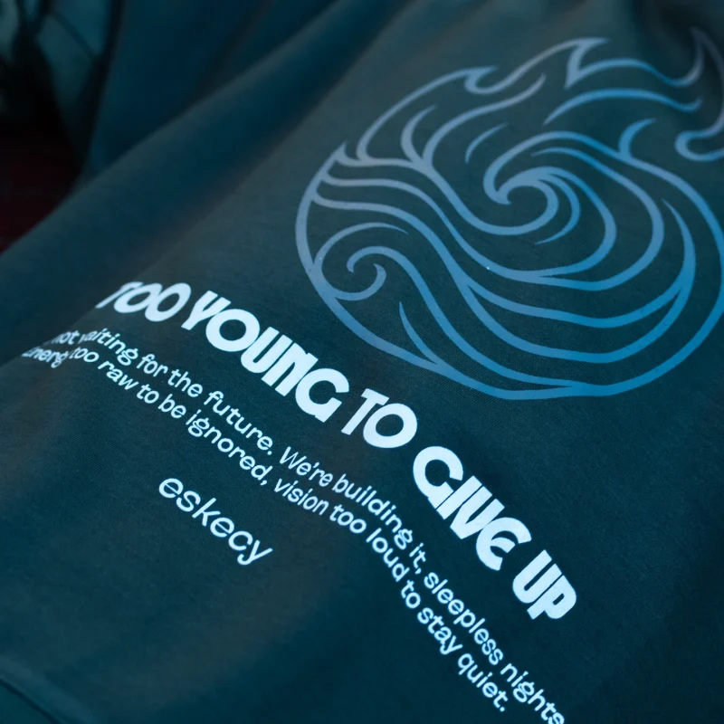 Eskecy Fire and Ice Hoodie – navy hoodie with wave graphic and "Too Young To Give Up" print