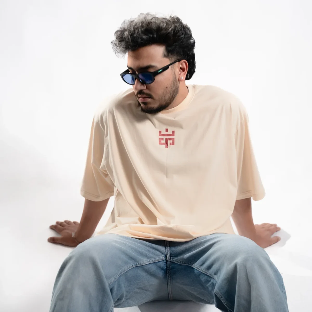 Model wearing the Eskecy Summer Beige Tee, a lightweight cotton t-shirt with subtle logo