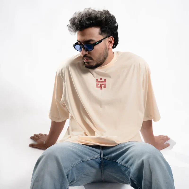 Model wearing the Eskecy Summer Beige Tee, a lightweight cotton t-shirt with subtle logo