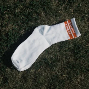 Eskecy white crew socks with orange logo stripe